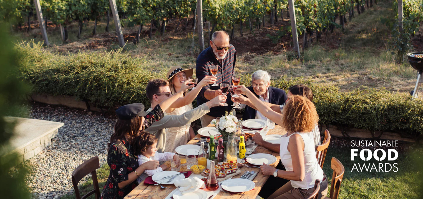 Family and friends gathered around a table enjoying FOLI Dressings