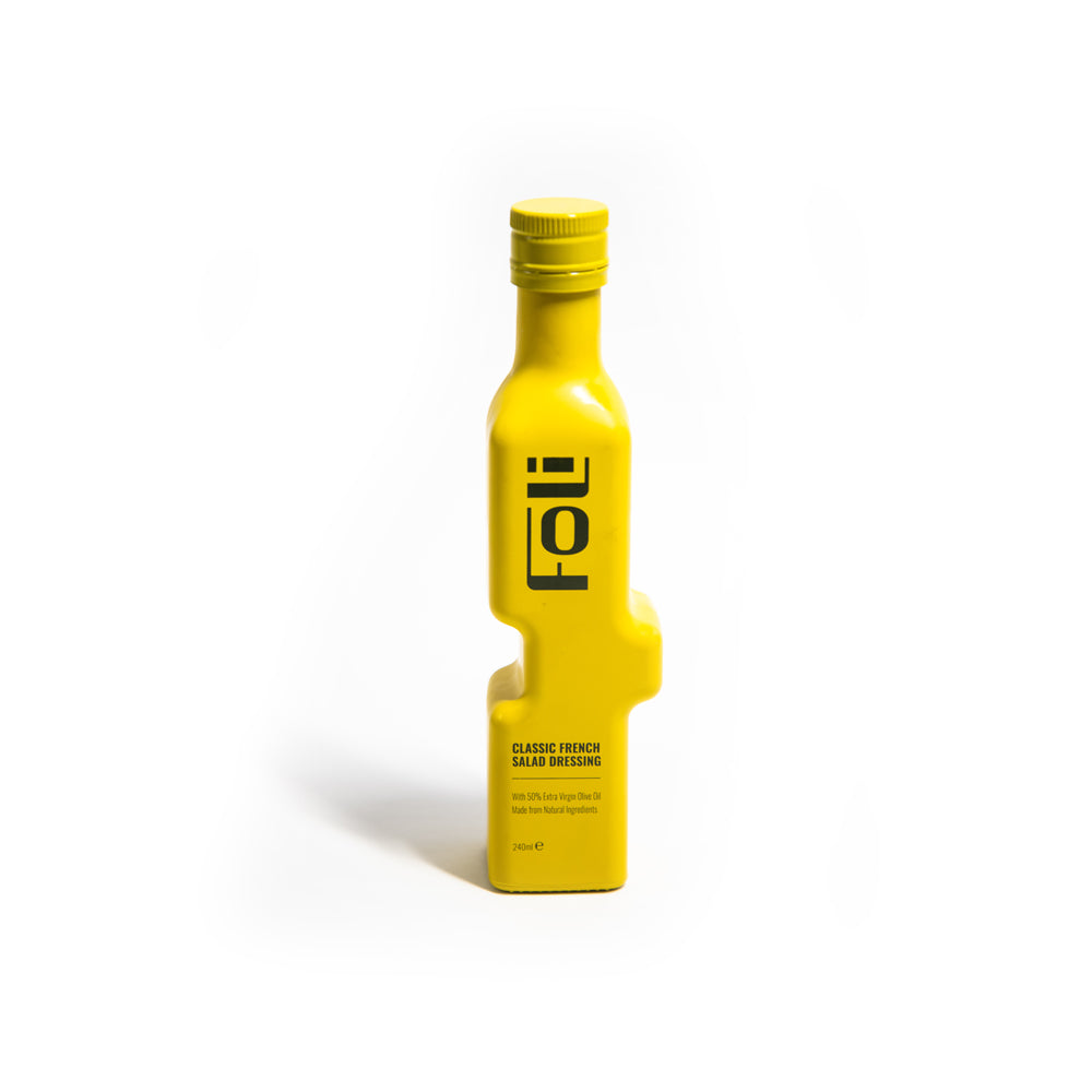 Yellow interlocking bottle of FOLI salad dressing on a white background